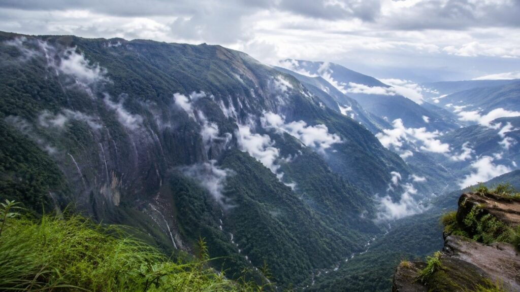 Monsoon in Meghalaya 2026,
Laitlum Canyon, Laitlum Canyon covered in mist during the Monsoon in Meghalaya, offering panoramic views of lush green valleys and rolling hills,